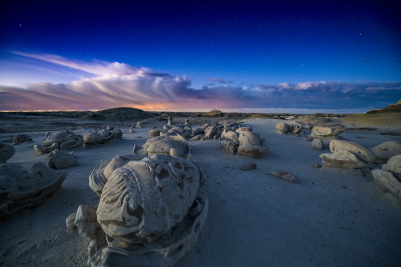 Sculpted rock formations beneath a twilight sky in the Bisti/De-Na-Zin Wilderness