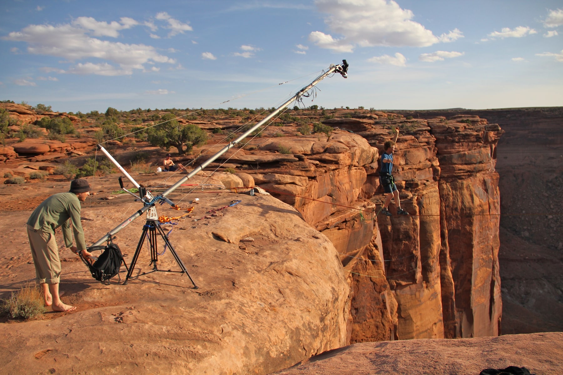 Camera crew operating a crane beside a red-rock canyon during an outdoor location shoot in Moab, Utah